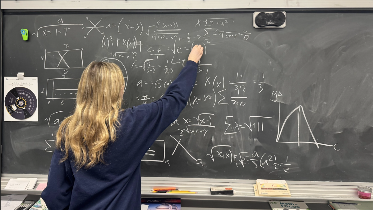 A freshman works through advanced math problems, attempting to stay ahead of her class with college already in sight.